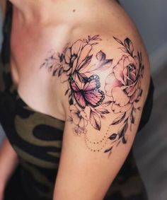 a woman with a butterfly and flowers tattoo on her shoulder