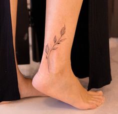 a woman's foot with a small flower tattoo on her left side calfocks