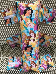 three disney princesses on blue and yellow pillowcases, one with pink hair