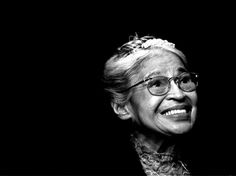 an old woman wearing glasses and smiling at the camera