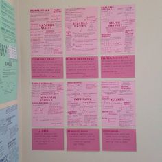 pink and green papers are on the wall next to each other with words written on them