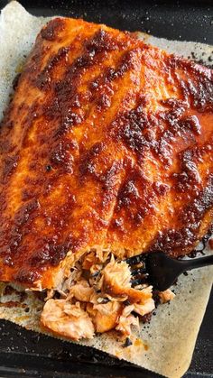 a bbq ribs covered in barbecue sauce on top of parchment paper