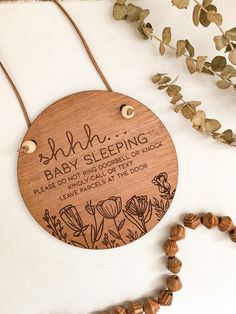 a wooden plaque with the words, baby sleeping on it