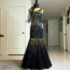 Gorgeous Mermaid Dress For Your Event. Fashioned With A One-Shoulder Design, This Beautiful Mermaid Gown In Black-Gold Exhibits An Appealing Pattern Of Sequins That Mimics The Look Of Gleaming Sun-Rays On The Torso And The Flared Floor-Length Skirt. The Sheer Shoulder Strap Extends To Blend Beautifully With An Asymmetrical Neckline And A Natural Waist For A Stunning Design. Size S Gold Mermaid Dress, Gold Mermaid, Floor Length Skirt, Beautiful Mermaids, Asymmetrical Neckline, Mermaid Gown, Stone Studs, Sun Rays, Mermaid Dress