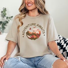 Unleash your adventurous spirit! Our "Adventure Awaits" tee is perfect for hikers, campers, and mountain explorers.  Crafted for comfort and style, this shirt is your perfect companion for outdoor escapades. Wear it as a reminder that your next adventure is just around the corner.    Care Instructions - Turn inside out and machine wash cold on delicate cycle - Dry on low heat setting - Do not bleach or dry clean - Do not iron directly on the design - Wash before wearing Shop FAQs - All items Mad Hiking Shirt With Letter Print And Crew Neck, Crew Neck Hiking Shirt With Letter Print, Relaxed Fit Graphic Print Top For Adventure, Casual Crew Neck T-shirt For Adventure, Casual Pre-shrunk Shirt For Adventure, Crew Neck Graphic Tee For Outdoor Activities, Crew Neck Graphic Tee Shirt For Outdoor Activities, Graphic Tee Shirt With Crew Neck For Outdoor Activities, Pre-shrunk Relaxed Fit Adventure Shirt