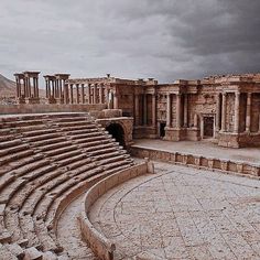 the ruins of an ancient roman city under a cloudy sky