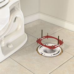 a white toilet sitting next to a hole in the floor with two poles sticking out of it