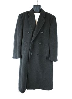 DESCRIPTION This is a great overcoat that was made by Gianfranco Ruffini.  The tag states that the fabric is a cashmere blend, and the fabric is from Italy.  The material is woven in shades of dark gray, and it has a soft texture.  The coat is fully lined, and it has a kick pleat in the back.  It closes with a row of buttons down the front, and there is a second row of ornamental buttons, giving it a double breasted look.  The coat also has two side pockets and two inside pockets.  SIZING The ta Mens Top Coat, Topcoat Men, Grey Overcoat, Overcoat Men, Gray Cashmere, Mens Top, Wool Overcoat, Long Trench, Trench Jacket