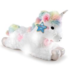 a white stuffed unicorn laying down with lights on it's face and ears,