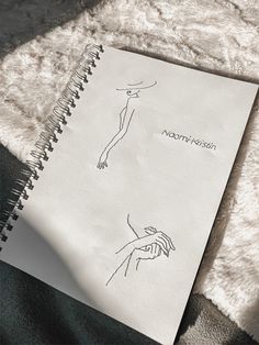 a notepad with a drawing of a woman's hand on it