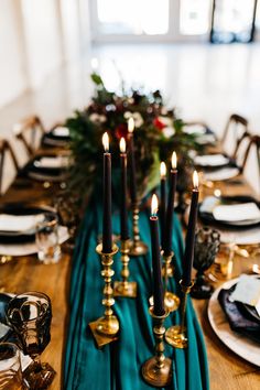 the table is set with candles and place settings