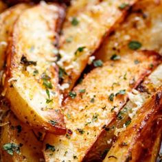 sliced potatoes with parmesan cheese and herbs on top, ready to be eaten