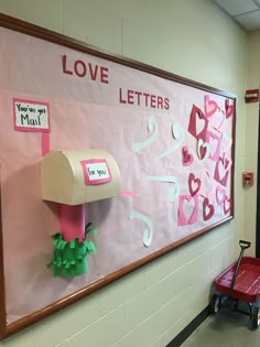 a bulletin board with pink and white paper on it that says love letters, you're mail