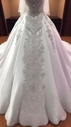 a white wedding dress on display in front of a window