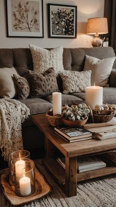 a living room filled with lots of furniture and candles on top of a coffee table