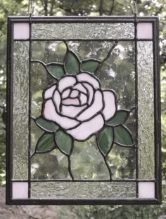 a stained glass window with a rose on it