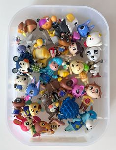 a plastic container filled with lots of small toy animals