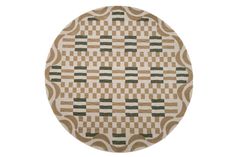 a round rug with green and brown squares on it, in the shape of a circle