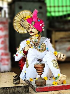 a statue of a person sitting on top of a table