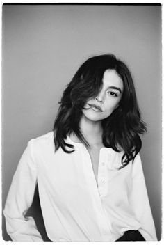 a black and white photo of a woman with long hair