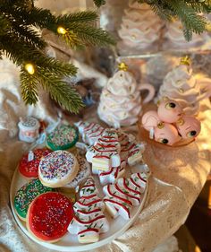 christmas cookies on a plate under a tree