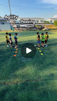 kids are playing soccer on the grass in front of a building with words that read agility passing