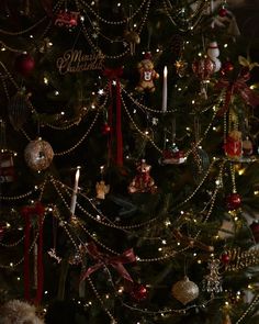 a decorated christmas tree with candles and ornaments