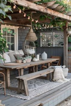 a wooden table sitting on top of a patio under a pergoline covered roof