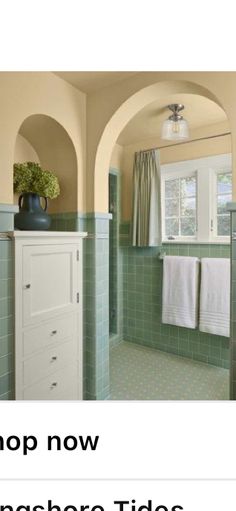 a green tiled bathroom with white cabinets and towels hanging on the wall, along with text that reads shop now