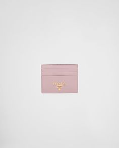 a pink card case with gold lettering on the front and bottom, against a white background