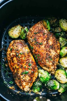 chicken and brussel sprouts in a skillet with some seasoning