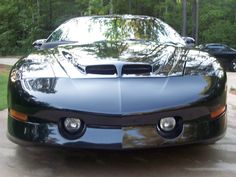 a black sports car parked in a driveway