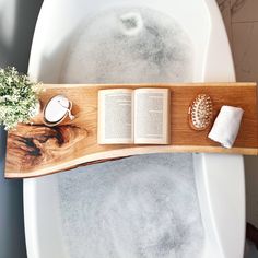 an open book on top of a bath tub