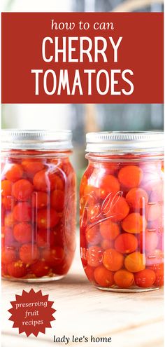 two jars filled with cherry tomatoes sitting on top of a table