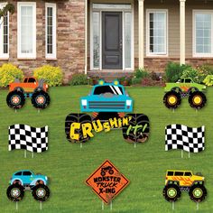 monster truck yard decorations in front of a house with checkered flags and lawn signs