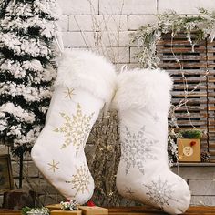 two white christmas stockings sitting on top of a wooden table