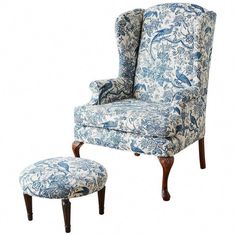 an upholstered chair and footstool with blue floral fabric