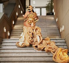 a woman is sitting on the stairs with her hands in her hair and wearing a costume