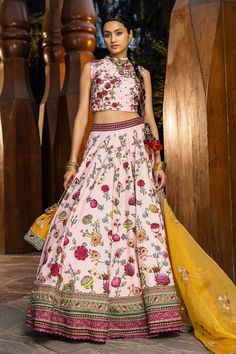 Blush pink lehenga with all-over floral printed motifs, embroidered border and cutwork hem. Paired with printed blouse. Comes with a yellow embroidered dupatta.
Component: 3
Pattern: Printed, Embroidered
Type Of Work: Floral motifs
Neckline: Round neck
Sleeve Type: Sleeveless
Fabric: Blouse and lehenga skirt: Natural silk, Dupatta: Soft net
Color: Pink
Other Details: 
Back zipper
Printed motifs
Cutwork hem lehenga
Note: The necklace, bag shown, blue lehenga set and outfit worn by the other male Mehandi Outfits, Sangeet Outfit, Blue Lehenga, Lehenga Skirt, Pink Lehenga, Natural Silk, Blouse Length, Bridal Set, Floral Motifs