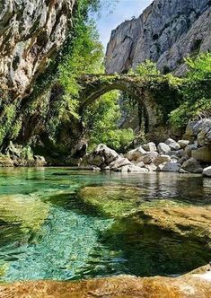 an image of a river that is in the middle of some rocks and trees on it