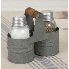 two salt and pepper shakers sitting on top of a table