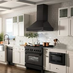 a kitchen with white cabinets, black appliances and wood flooring is seen in this image