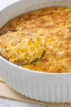 a casserole dish filled with corn and cheese