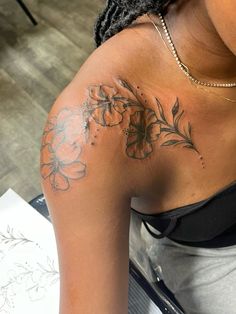 a woman with a flower tattoo on her back