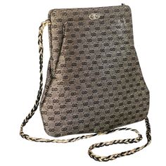 Over the past several years, Gucci has risen to a monumental status. Their classic and quirky designs have placed the Italian design house at the forefront of luxury brands. Done in a metallic gold and black satin, this Gucci bag gives off a lustrous slightly nickel hue. It is shaped in the form of a knapsack with a gold and black silk braid strap. This combination gives off a luxe yet casual vibe. Decorative hardware in the GG Gucci logo graces the front of this bag. A sleek design at a manageable size, this Gucci bag is versatile and could pair excellently for a cocktail or more formal occasion. Shoulder strap drop: 21 inches Height: 8 inches Width: 8 1/4 inches at bottom, 6 inches at top Depth: 0.5 inches At the top, the bag opens with a snap fastener. Inside, the purse is lined in a bl Gucci Coat, Embroidered Shoulder Bag, Black Evening Bag, Gucci Brand, Satin Noir, Gucci Outfits, Gucci Logo, Gucci Bamboo, Quirky Design