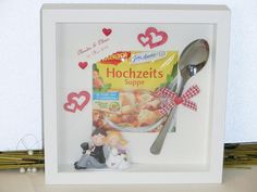 a photo frame with a spoon and couple figurines