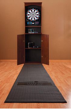 an entertainment center with darts and darts on the door, in front of a brown wall