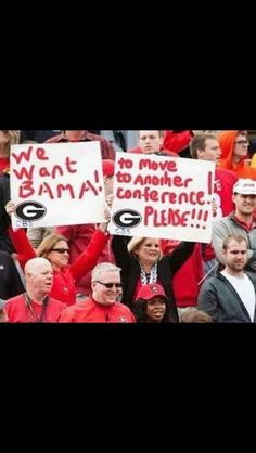 fans holding up signs in the stands at a football game that read, we want to move to another conference please