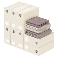 a stack of white boxes with towels on top