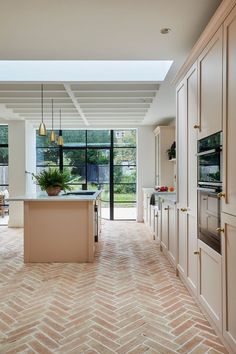 an open kitchen and dining room with large windows